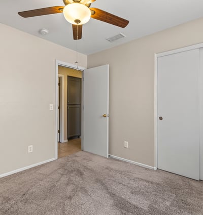 Inviting bedroom with neutral finishes, ceiling fan, and natural light ready for personalization.