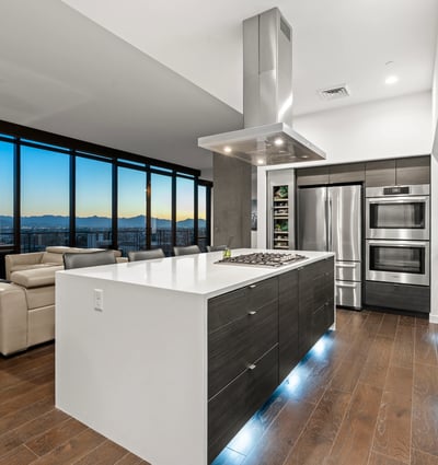 Contemporary kitchen with expansive island and panoramic Phoenix views, enhanced by energy-efficient appliances and modern finishes.