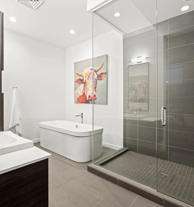 Contemporary bathroom featuring a large glass shower, freestanding tub, and designer tile, combining luxury and functionality.