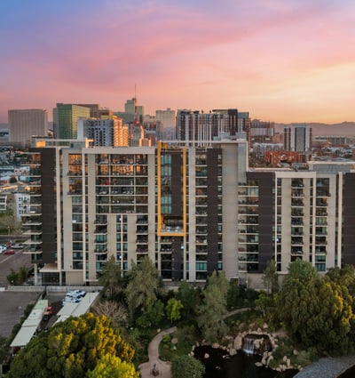 Expansive views blending city skyline with mountain backdrops at sunset, adding natural beauty to this Phoenix property.