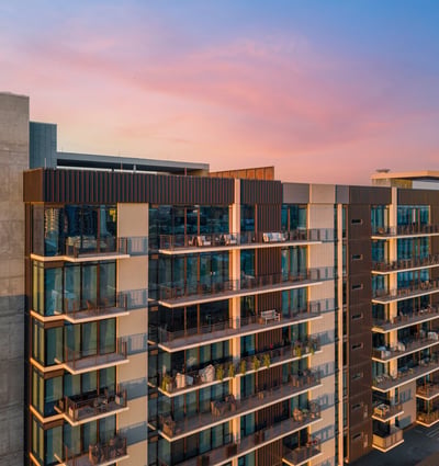 Contemporary building exterior with multiple private balconies and updated design elements, highlighting upscale living in Phoenix.