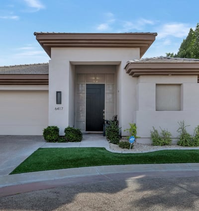 Clean-lined exterior with a private entry and attached garage in a sought-after Phoenix gated community. Designed for low-maintenance living and modern appeal.