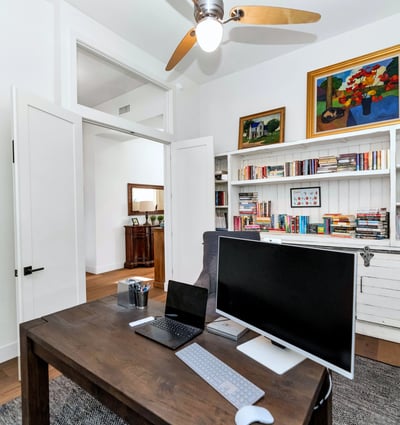 Home office with built-in bookshelves and storage, providing both style and practicality in this Phoenix residence.