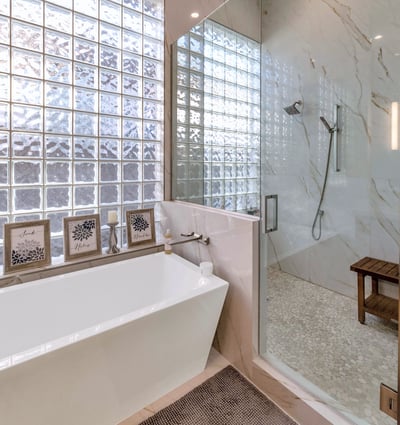 Contemporary glass shower with detailed tile work and upgraded fixtures, enhancing the bathroom design in this Phoenix home.