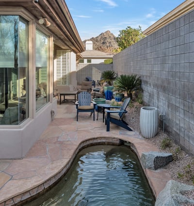 Peaceful outdoor space with a water feature, patio seating, and scenic views, offering relaxation in this Phoenix property.