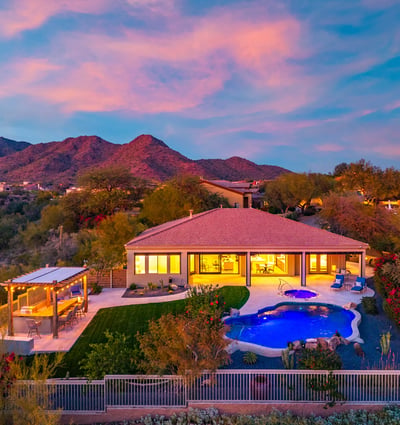 Stunning backyard retreat featuring pool, spa, pergola, and lush lawn, designed for Scottsdale outdoor living with panoramic mountain scenery.