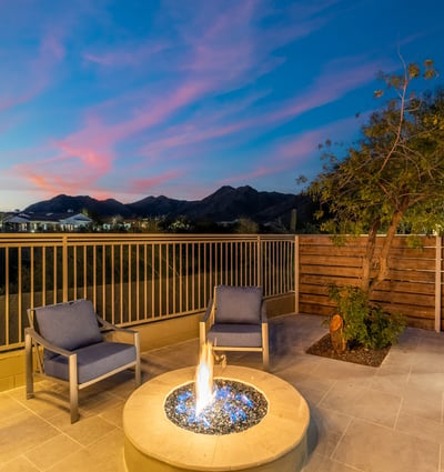 Private patio with modern fire feature and comfortable seating, offering breathtaking Scottsdale mountain views and peaceful outdoor ambiance.