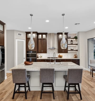 Light-filled kitchen with modern finishes, large island, and open layout connecting seamlessly to the Scottsdale living space.