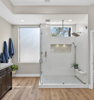 Upgraded Scottsdale bathroom showcasing a glass-enclosed shower, custom tile accents, and modern fixtures.