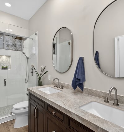 Modern Scottsdale bathroom featuring dual sinks, quartz counters, and a sleek glass shower with updated fixtures.