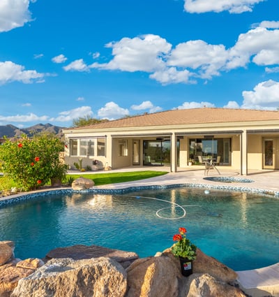Scottsdale backyard featuring spa, pool, and expansive patio space with desert views, perfect for entertaining and relaxation.