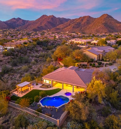 Scottsdale aerial view highlighting the backyard with pool, spa, and landscaped yard, offering privacy and desert surroundings.