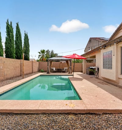 Inviting backyard with pool and low-maintenance design. Perfect for cooling off and entertaining in this Casa Grande home.