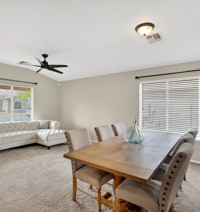 Dining area with large windows and inviting atmosphere. Ideal for gatherings and everyday meals in this Casa Grande home.