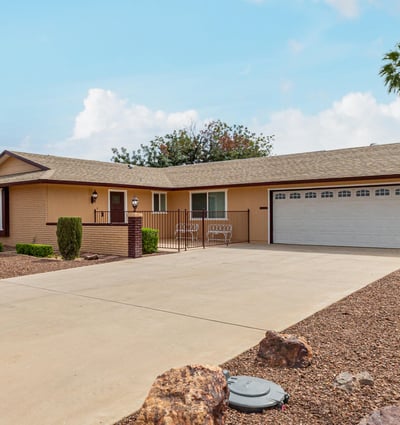 Clean exterior with attached two-car garage and extended driveway. This updated Sun City home provides convenience, storage, and modern upgrades.