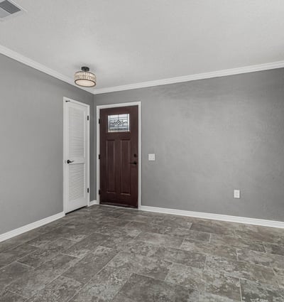 Entryway with sleek tile flooring, fresh paint, and updated lighting. This Sun City home offers a clean, contemporary interior feel.