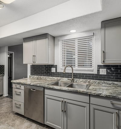 Updated kitchen with granite countertops, modern cabinetry, and sleek finishes. This Sun City home delivers both style and functionality.