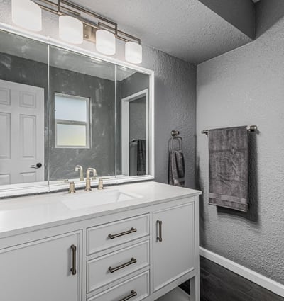 Updated bathroom vanity with sleek countertop, modern fixtures, and bright lighting. This Sun City home offers refreshed spaces with stylish upgrades.