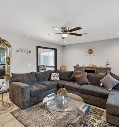 Inviting living room with updated flooring and abundant natural light, enhancing the overall appeal of this Phoenix remodeled home.