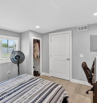 Light-filled bedroom featuring updated flooring, closet space, and a functional layout.