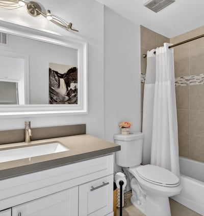 Scottsdale bathroom with modern vanity, framed mirror, and tiled tub-shower combo, delivering style and everyday convenience.