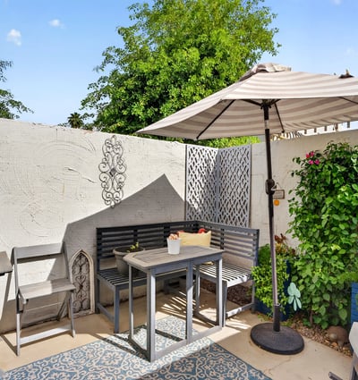 Comfortable Scottsdale patio with seating, shade, and garden accents, creating a warm and welcoming outdoor space.