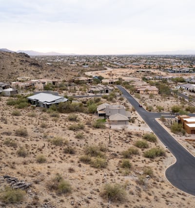 Exceptional aerial perspective showcasing the property s elevated setting among scenic desert terrain and luxury homes. Build your dream residence surrounded by breathtaking Phoenix mountain views.