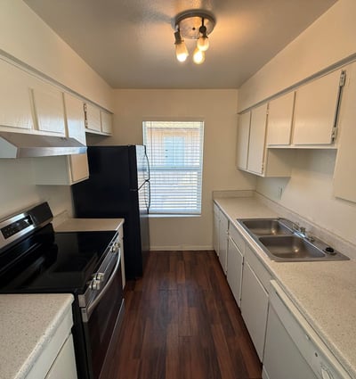 Functional galley-style kitchen featuring extensive cabinetry, generous counter space, and modern appliances. Designed for convenience, this space supports both everyday cooking and efficient organization.