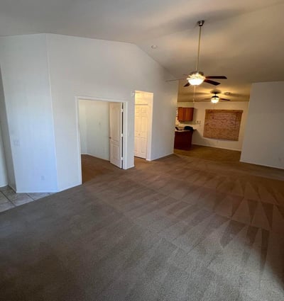 Open-concept great room featuring soaring ceilings and easy access to adjacent living spaces. The flowing floor plan creates a welcoming atmosphere perfect for modern living and entertaining.