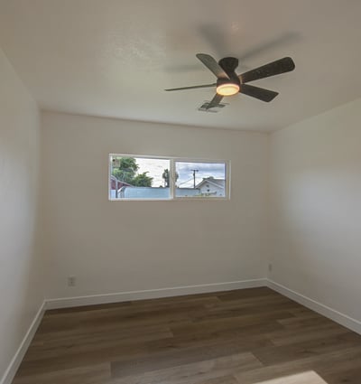 Offering updated flooring, neutral finishes, and a ceiling fan, this comfortable bedroom adapts easily for family, guests, or a productive home office.