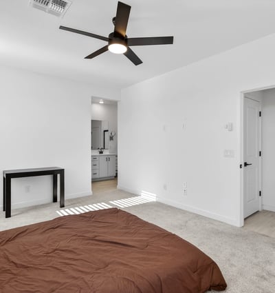 Featuring generous dimensions, soft natural light, neutral finishes, and direct access to the ensuite bath, this comfortable primary bedroom creates a relaxing owner's retreat.