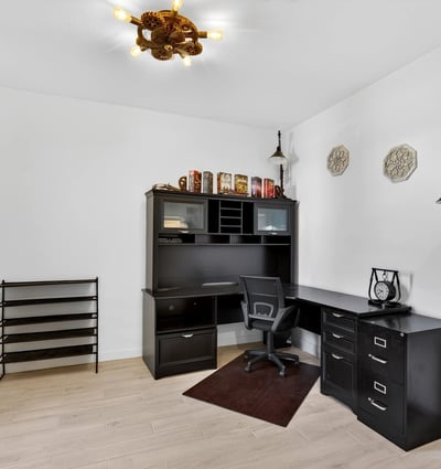 This dedicated office offers generous workspace, wood-look tile flooring, and plenty of room for working from home, studying, or creating a personalized flex space.