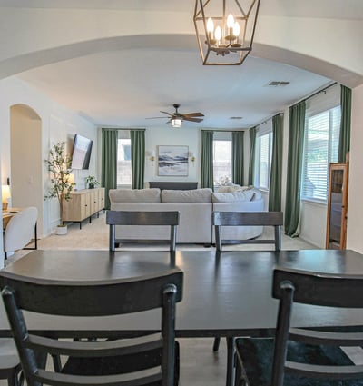 Spacious dining room overlooking the inviting family room through an elegant arched opening, creating a seamless layout that's perfect for entertaining and everyday gatherings.