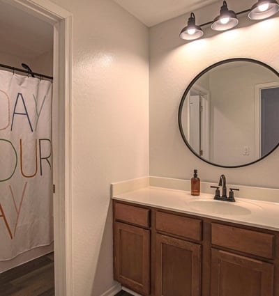 Bright secondary bedroom with plush carpeting, ceiling fan, generous natural light, and space for a desk or workspace. A versatile room perfect for family, guests, students, or working from home.