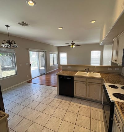 This bright kitchen connects seamlessly to the family room and covered patio, providing an ideal layout for entertaining while offering generous prep space and storage.