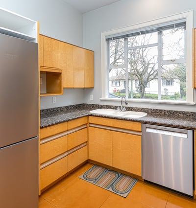 Bright and functional kitchen featuring modern appliances, ample storage, and a convenient window for natural light.