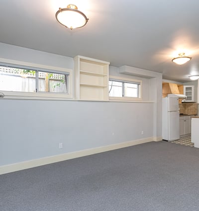 Bright, versatile space with ample natural light, perfect for a home office or cozy gathering area.