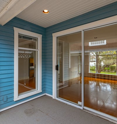 Bright, inviting entryway with large glass doors leading to a spacious, light-filled living area.
