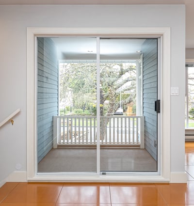 Bright and inviting space with sliding glass doors leading to a cozy patio and garden view.