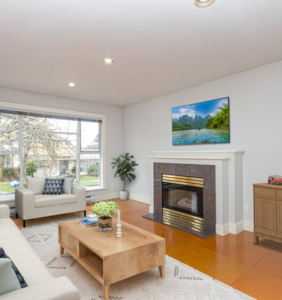 Bright and spacious living room featuring a modern fireplace and large windows for natural light.