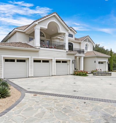 Stunning Oak Knoll Summit home featuring 4 spacious garages and beautifully landscaped grounds, perfect for entertaining and outdoor living.