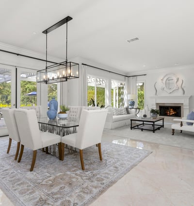 Bright and spacious living area with large windows, a cozy fireplace, and a seamless outdoor connection.