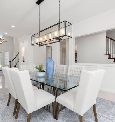 Bright and airy dining area, featuring a modern glass table and plush seating, perfect for gatherings.