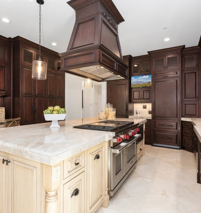 This gourmet kitchen features rich wood cabinetry, a spacious island, and premium appliances for culinary enthusiasts. 6 Burner Wolf Range with double ovens and griddle, 2 Bosch dishwashers, double sub zero fridges with 4 pull out freezer drawers, Wolf pull out microwave, tons of upgraded cabinets it pull out drawers, and so much more