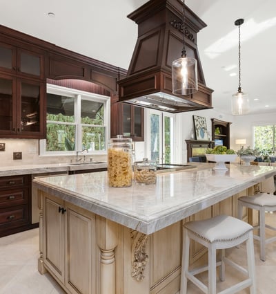 Spacious kitchen featuring a central island, modern appliances, and abundant natural light from large windows.