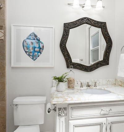 En-Suite Bathroom for Bedroom 1 
Bright bathroom featuring a decorative mirror, modern fixtures, and unique artwork, enhancing its inviting atmosphere and private direct access door to backyard
