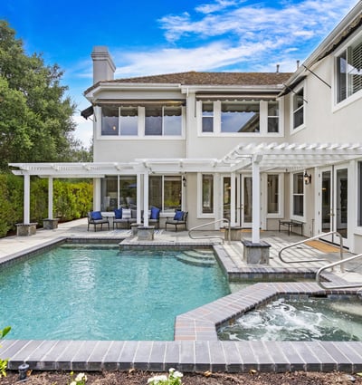 This inviting backyard features a spacious pool and spa, perfect for entertaining and relaxation.