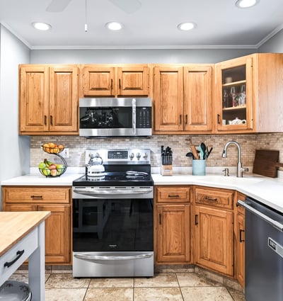 Charming kitchen with warm wood accents, Corian counters.