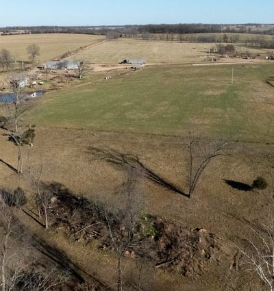Looking east along MvDonald Road, the north boundary road. Cattle pens, corral and operations HQ.