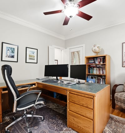 Spacious home office featuring dual workstations, ample storage, and natural light for productive days.